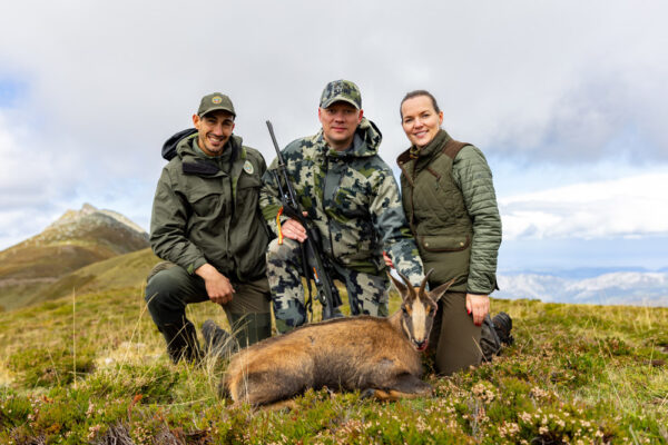 couple hunting trips in spain Hunters pose with a rifle.